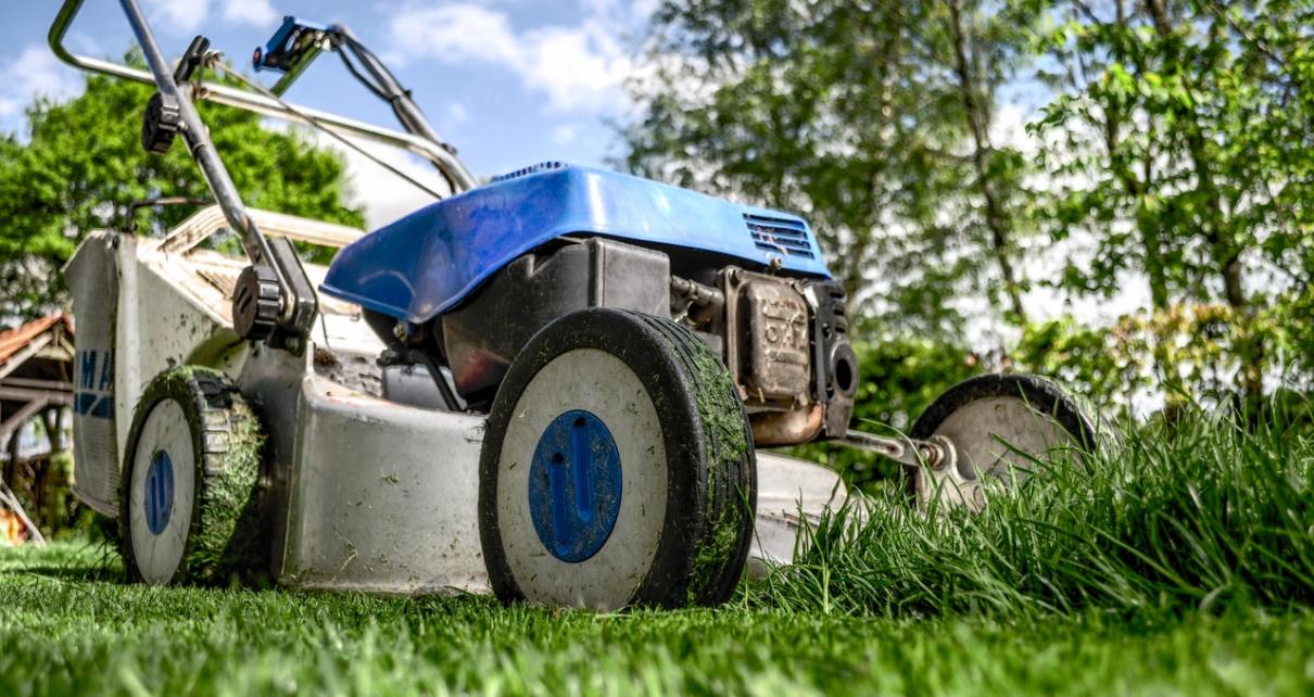 a blue lawn mower on the grass
